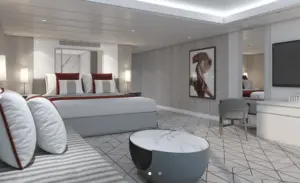 Slaapkamer van de Sky Suite op de Celebrity Ascent met kingsize bed en modern interieur met uitzicht op zee