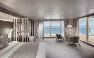 Bovenaanzicht diagram van de World Atlantic Yacht Club binnenhut met tweepersoonsbed, zithoek en badkamer.